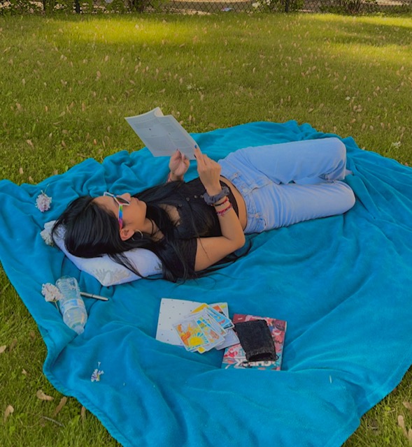 picture of me reading on a blanket outside